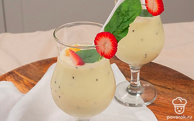 Перелейте смузи с бананом, киви и яблоками в высокие стаканы, украсьте кусочками апельсина и клубники.