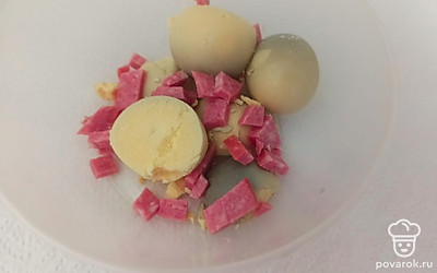 Колбасу нарезаем мелкими кубиками и смешиваем с желтками.