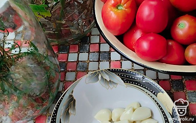 В чистые банки сначала укложить зелень, а затем утрамбовать плотно помидоры, перец и чеснок.