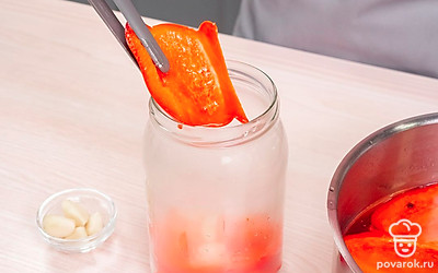 Замаринуйте перец. Разложите перец по банкам вместе с чесноком. Когда обработанный перец закончится, сварите в маринаде новую партию. Когда весь перец будет уложен, разлейте по банкам маринад, закройте крышки и уберите их в сухое место на 1 сутки.