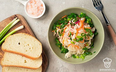 Капусту с айвой выложите в глубокую пиалу, полейте растительным маслом, посыпьте измельченным зеленым луком.