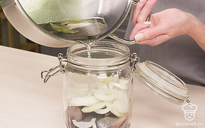 Положите сельдь в маринад. Возьмите банку объемом 0,5 л и аккуратно сложите в нее куски селедки и лук слоями. Налейте в банку маринад и закройте крышку. Выдержите в холодильнике 12 часов.