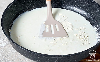 Всыпьте в теплое молоко остывшую муку, тщательно размешайте, разбивая и растирая лопаткой комочки. 