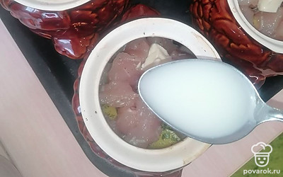 Распределите сливочный соус равномерно на все горшочки.