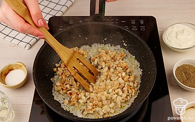 Добавьте к луку шампиньоны и обжаривайте все, постоянно помешивая, 5 минут.