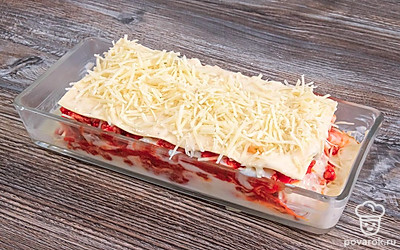 В среднем должно получиться 4-5 слоев. Самый верхний слой сделайте таким образом: на тертый сыр положите листы пасты, полейте соусом бешамель и посыпьте снова тертым сыром.