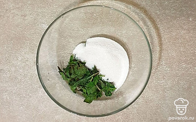 В глубокую миску выложите мяту, всыпьте сахар. Пробейте все погружным блендеров в кашу.