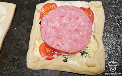 Выложите колбасу. Сделайте бортики по краям, поместите пиццу в духовку. Выпекайте 12-15 минут до тех пор, пока тесто не станет золотистым. Сыр расплавится и немного подрумянится.