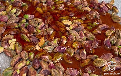 Залейте карамелью нагретые фисташки, добавьте щепотку соли. Измельчите полученную массу до состояния густой пасты.