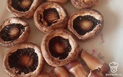 Шампиньоны промойте, аккуратно отделите ножки от шляпки.