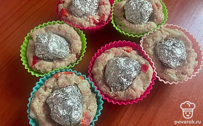 Из фарша сформируйте шарики. Уложите смесь в силиконовую формочку. В середину положите шарик из фольги, чтобы сформировать «корзинки» . Отправьте формочки в духовку при 160 градусах на 10 минут. 