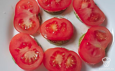Выложить сверху ломтики помидора.