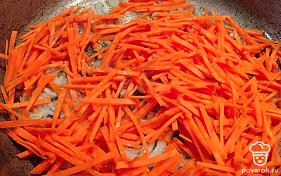 На раскаленной сковороде с растительным маслом обжарьте нарезанные лук и морковь.