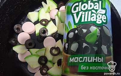 Добавьте нарезанные колечками маслины.