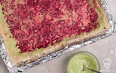 Выложите слой тертой свеклы. Снова смажьте соусом.