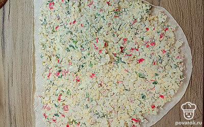 На лист лаваша распределить начинку и свернуть в рулет.