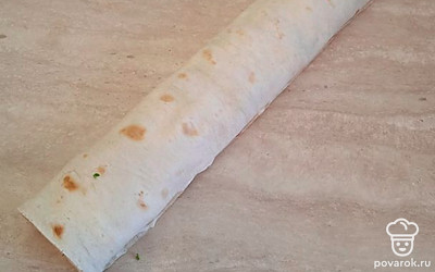 Сверните лаваш в рулет и уберите в холодильник на 10 минут. 