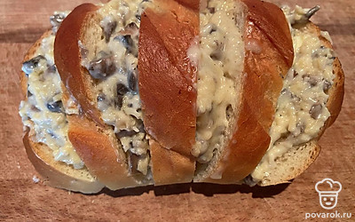 Смажьте батон грибным маслом и отправьте в духовку на 5 минут до румяности.