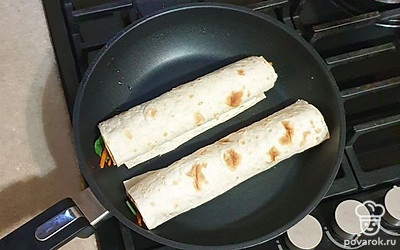 Лаваш сверните в рулеты и выложите на сухую сковороду, обжарьте с двух сторон.