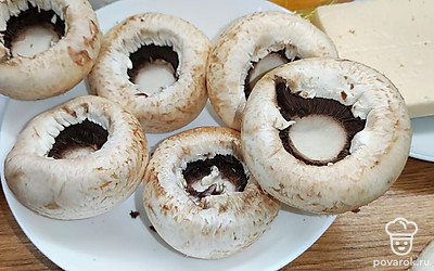 Грибы помыть, обсушить. Вырезать у грибов ножку, подрезать немного шляпку для ровной поверхности.