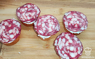 Сверху положить кусочек колбасы.