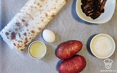 Подготавливаем продукты. Нарезаем лаваш полосками по 8-10 сантиметров в ширину. Разогреваем сковородку. Картофель ставим вариться в кожуре.