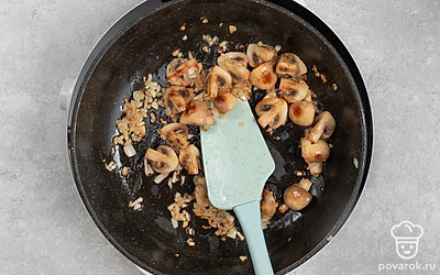 Добавьте к луку нарезанные дольками грибы. Тушите их, периодически помешивая, 10 минут. После этого выключите огонь.