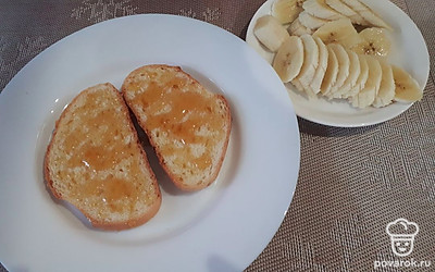 Нанесите мед на кусочки хлеба или батона.