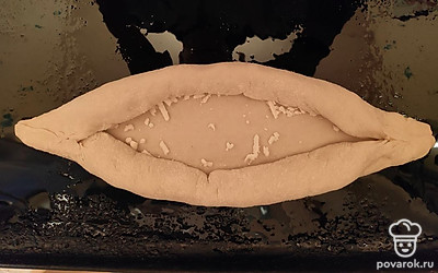 Сверните бортики к центру и сформируйте края лодочки, прищипнув тесто по бокам. 