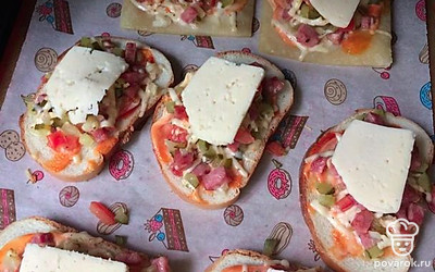 На хлеб, смазанный кетчупом и майонезом, выкладываем начинку. Сверху кладем один кусочек сыра и отправляем выпекаться в духовку на 20 минут при 180 градусах (или до подрумянивания и расплавления сыра).