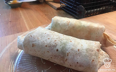 Сворачиваем рулетом, загнув края внутрь, чтобы рулет получился закрытым, и начинка не торчала.