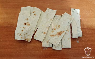 Сверните лаваш и нарежьте пластинками.