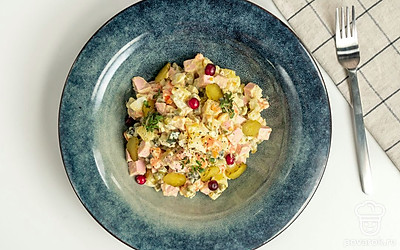 Оливье с колбасой перед подачей украсьте листиками свежей петрушки.