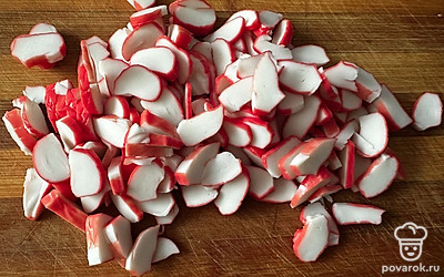 Крабовые палочки тонко нарезать.