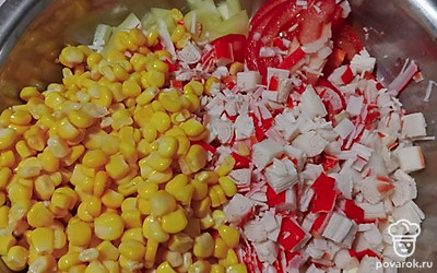Кубиками нарезаем крабовые палочки, сливаем воду из кукурузы и высыпаем все в миску.