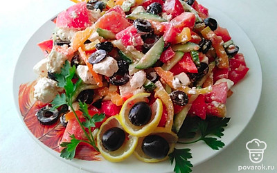 Выложите порционное количество салата на тарелку и украсьте дольками лимона и маслинами.