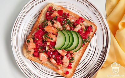 Выложите брускетту на тарелку, дополните ее ломтиками свежего огурца и подайте на стол.