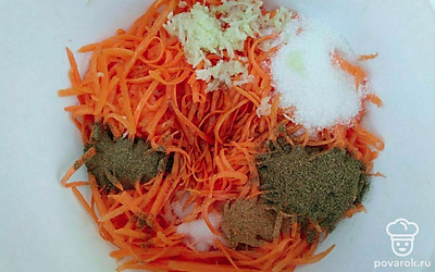 Приготовьте корейскую морковь. Для этого в натертую морковь добавьте кориандр, соль, сахар, мускатный орех, измельченный чеснок, залейте подогретым соевым соусом и подсолнечным маслом.